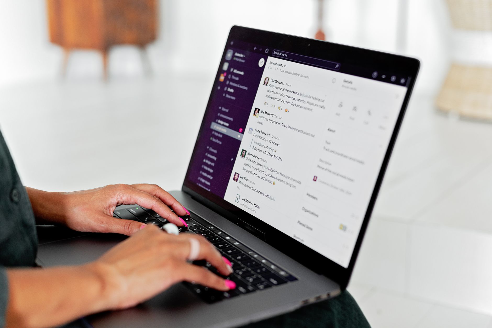 Person typing on a laptop with an AI chat assistant visible on the screen